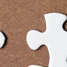 white jijgsaw puzzle with sevreal pieces missing