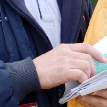 detail of photo showing USPS delivery person handling mail