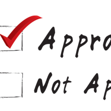 hand with marker checking a box next to "approved"