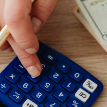 woman calculating money and receipts using calculator