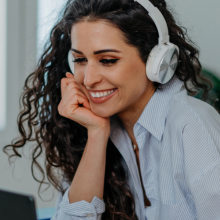 Person with headphones talking via computer