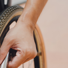 hand on wheelchair wheel 