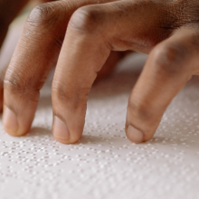 hands reading braille 