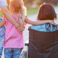 family facing sunset