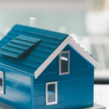 house model placed on table alongside paperwork symbolizing property valuation