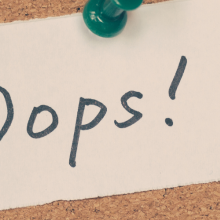 note on bulletin board saying "Oops!"