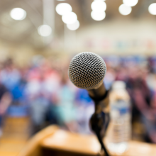 microphone on stage facing crowd