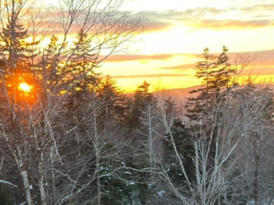 photo of Julie beside a beautiful Vermont sunset