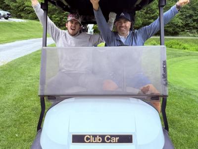 golfers in golf cart