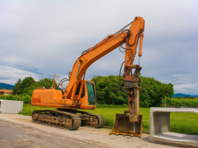 excavator parked next to a concrete box culvert