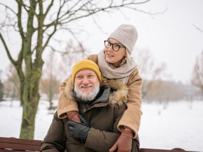 older couple on park bench in winter