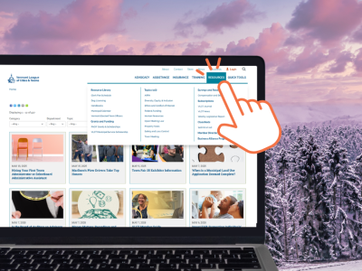 snowy background VLCT website on laptop in foreground