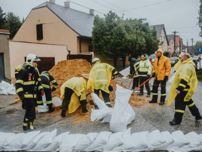 emergency workers filling sandbags to create sandbag wall