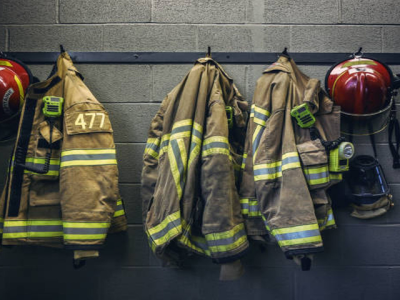 firefighter turnout gear hanging on a wall