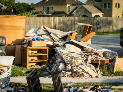 debris from flooded home piled on front lawn