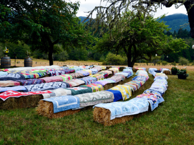quilt covered hay bales set up as amphitheater style seating