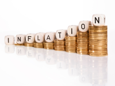 stacks of coins with the word "inflation" 