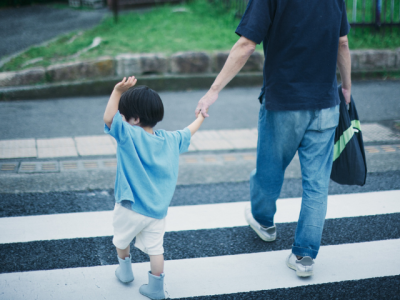 man and child in crosswalk