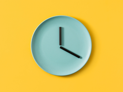 green clock on yellow background