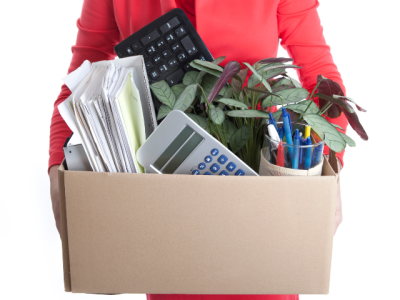 woman holding box of stuff from office. unemployed. 