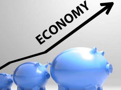 ECONOMY and rising arrow above piggy banks