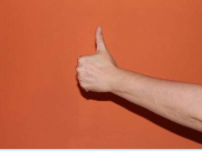 photo of hand giving a thumbs-up signal
