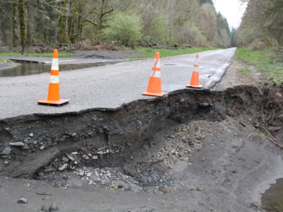 road washout with traffic cones