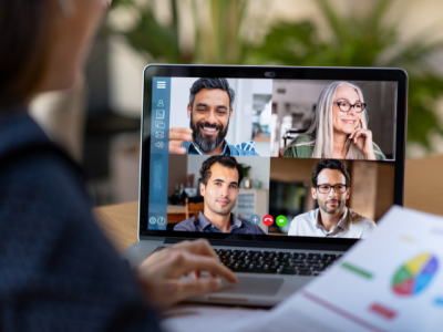 photo of computer screen with four people in a remote meeting