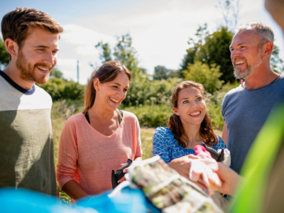 four smiling people in the outdoors