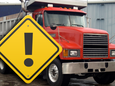 Dump truck with attention sign