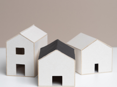 small white models of three simple buildings