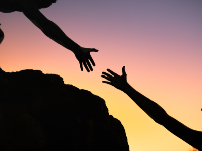 two hands reaching for each other