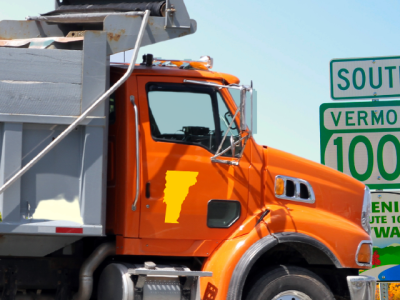 photo of dump truct near Vermont route signs