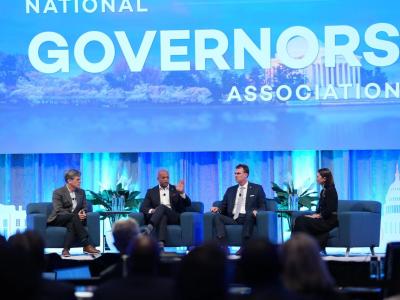 Tim Shriver with Governor Wes Moore, Governor Kevin Stitt, and Laura Collins from the George W. Bush Institute on stage at the 2026 National Governors Association meeting