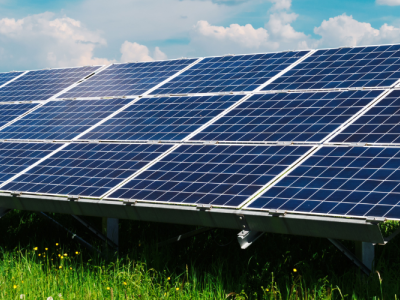 a large array of solar/PV panels in a field