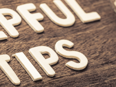 white letters spelling "helpful tips" on wood background with lightbulb