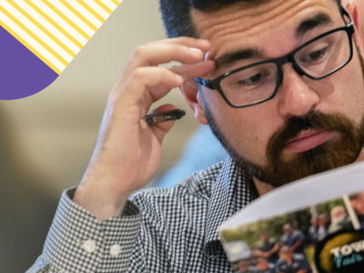 Photo of man looking at VLCT folder with accent shapes