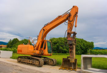 excavator parked next to a concrete box culvert