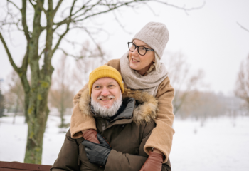 older couple on park bench in winter