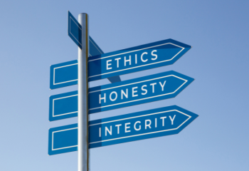 street sign post showing Ethics Honesty Integrity all pointing in the same direction
