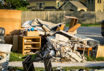 debris from flooded home piled on front lawn