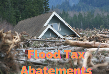 roof of home amid river debris with "Flood Tax Abatements"