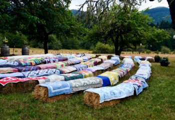 quilt covered hay bales set up as amphitheater style seating