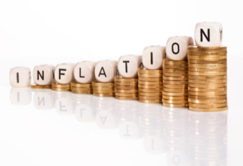 stacks of coins with the word "inflation" 