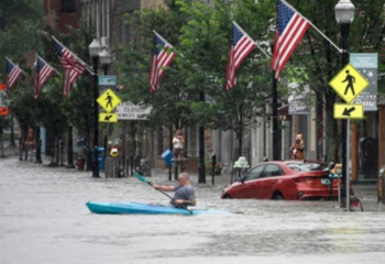 photo of kayaker in flooded downtown Barre, Vermont