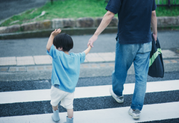 man and child in crosswalk