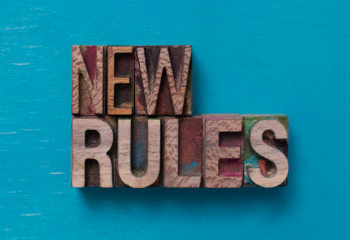 Woodcut block letters reading "New Rules" on teal background