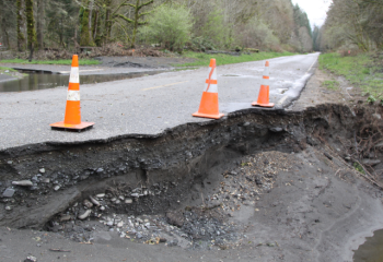 road washout with traffic cones