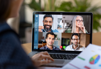 photo of computer screen with four people in a remote meeting