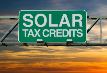 highway sign reading "solar tax credits"